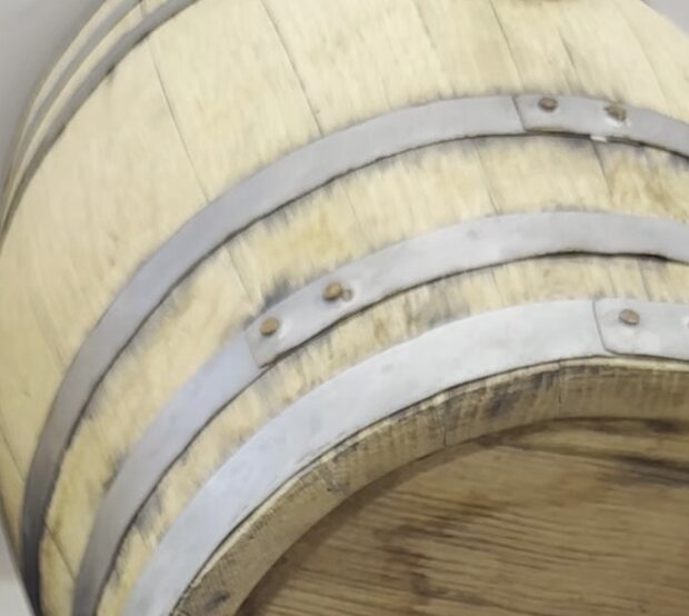 A small barrel resting in the cellar
